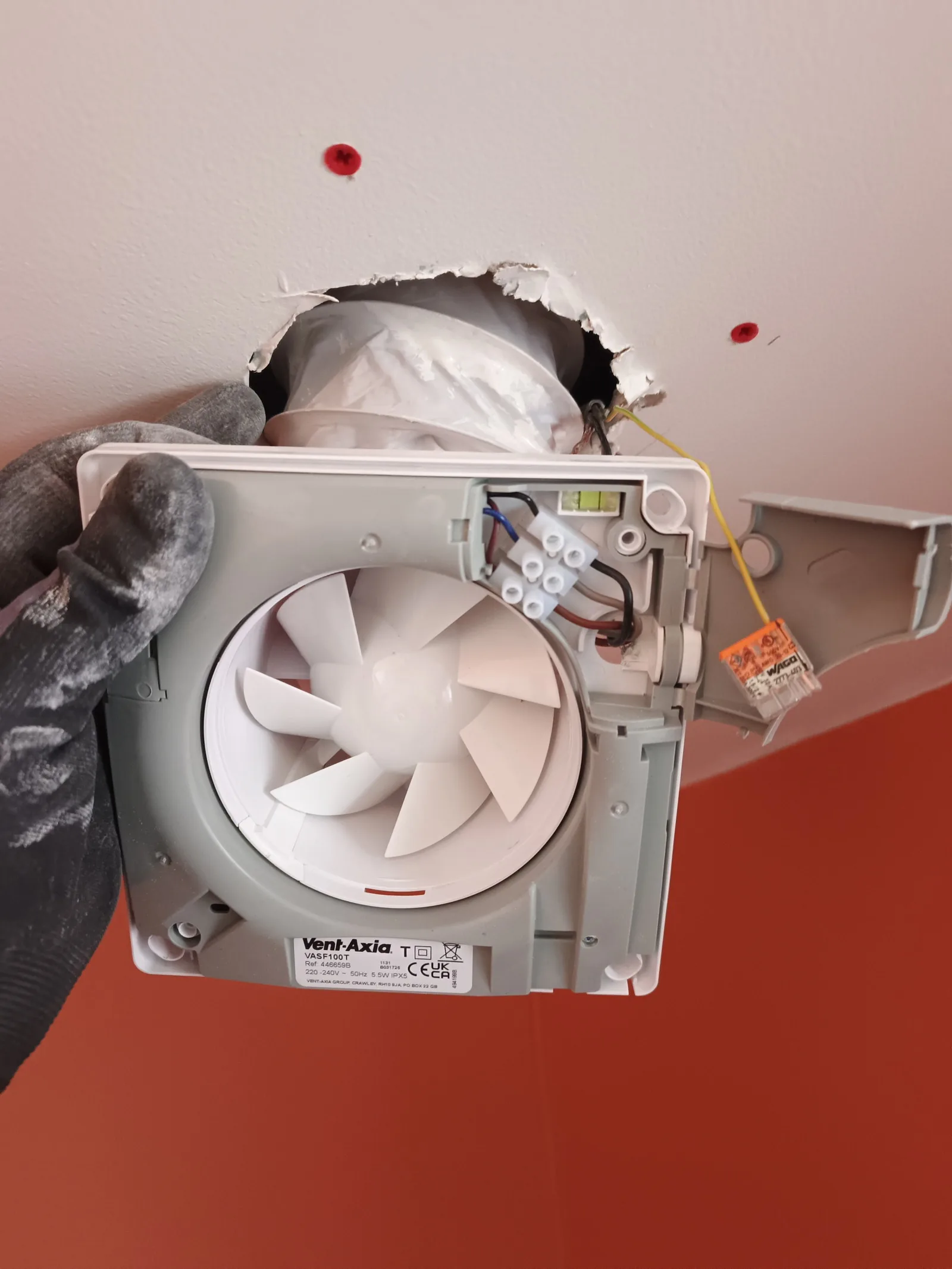 Vent-Axia bathroom extractor fan being fitted to ceiling ducting during a Bournemouth BH5 refurbishment