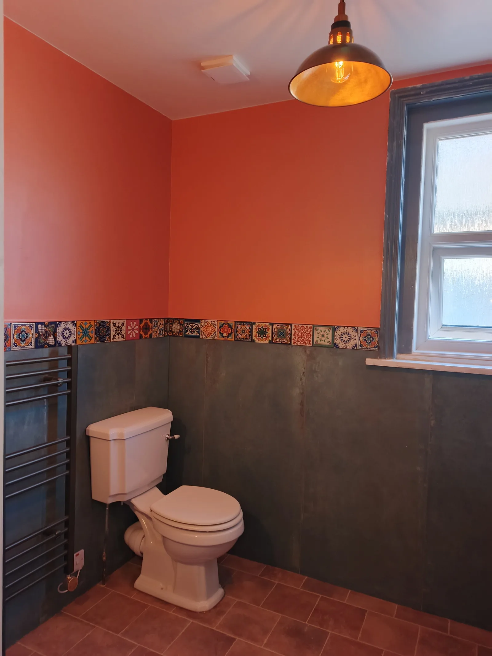 Finished bathroom in Bournemouth BH5 with ceiling extractor fan grille, pendant light and electric towel radiator