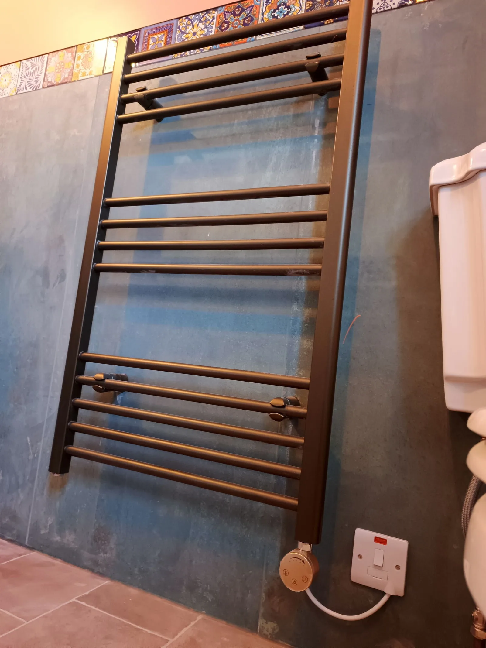 Electric towel radiator with heating element and switched fused spur in a Bournemouth BH5 bathroom