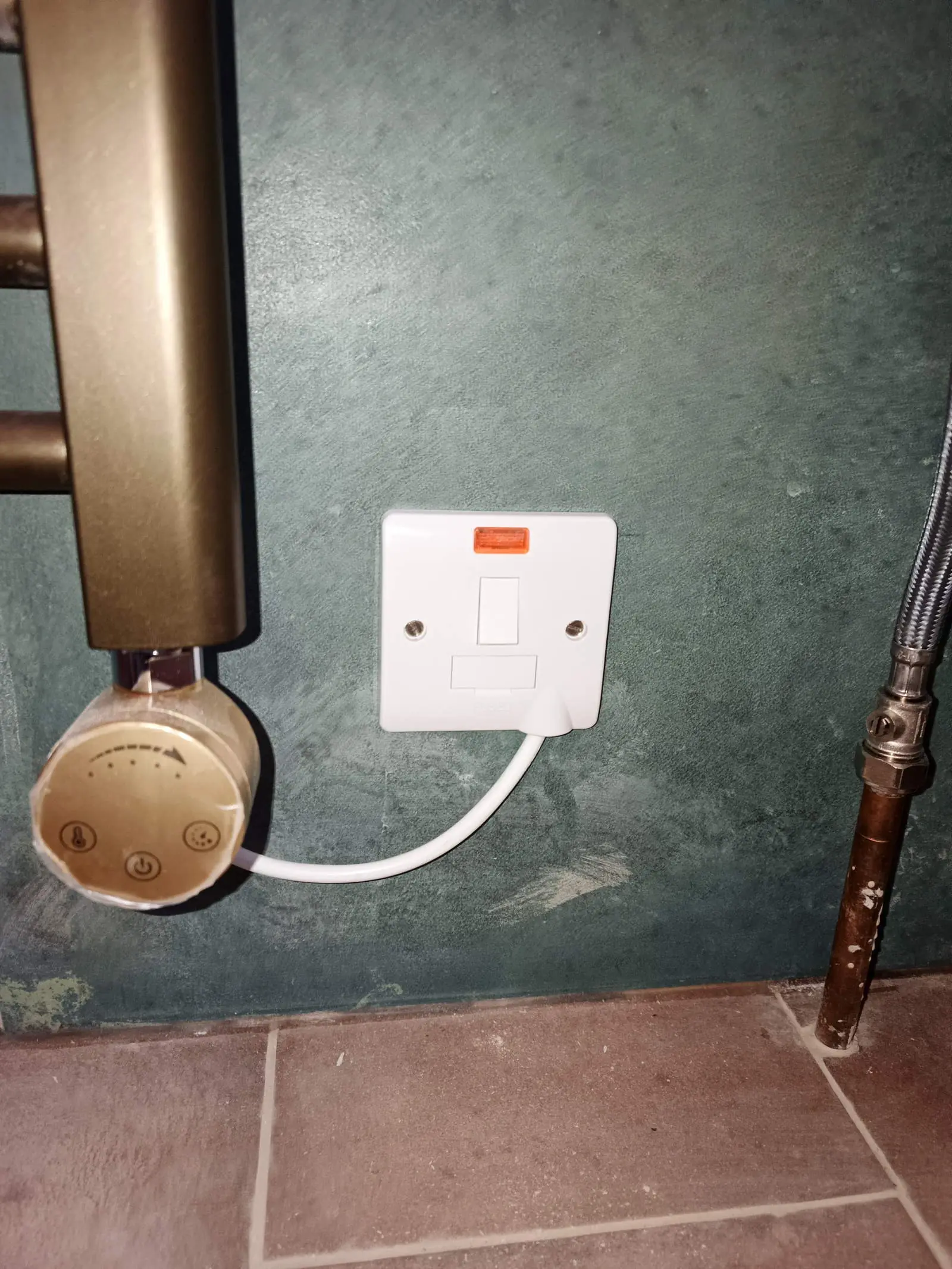 Switched fused spur with neon indicator and flex outlet feeding an electric towel radiator element, Bournemouth BH5