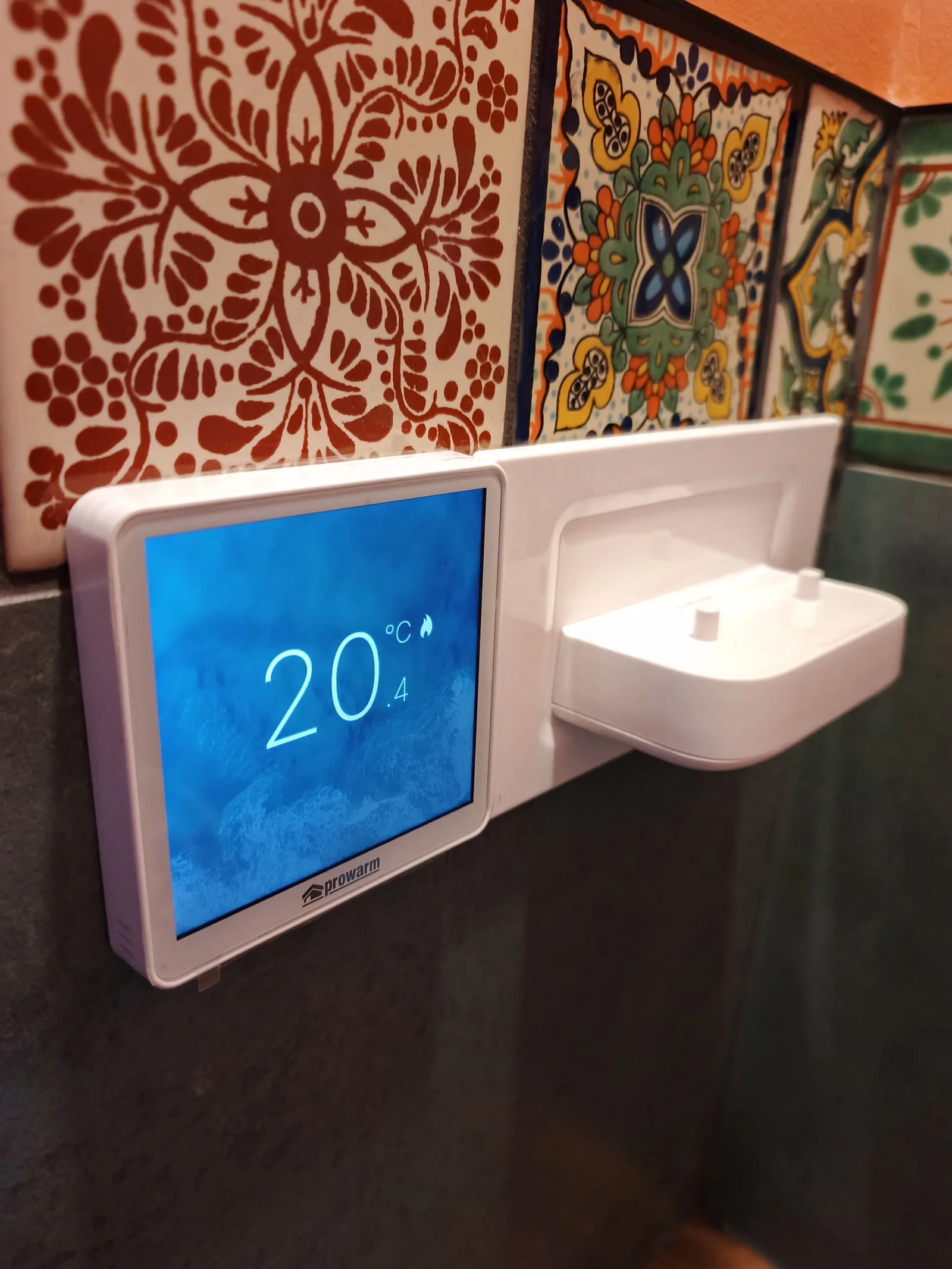 Prowarm underfloor heating thermostat beside a toothbrush charger in a Bournemouth BH5 bathroom