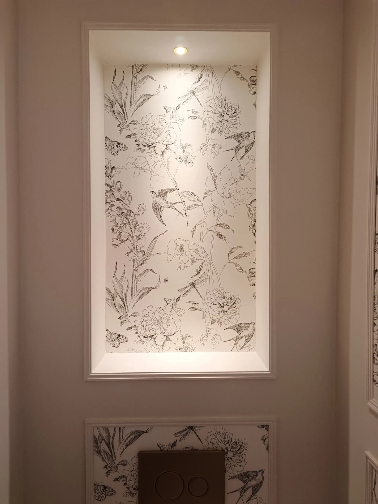 Recessed wall niche lit by a motion-sensor downlight in a cloakroom in Poole BH14