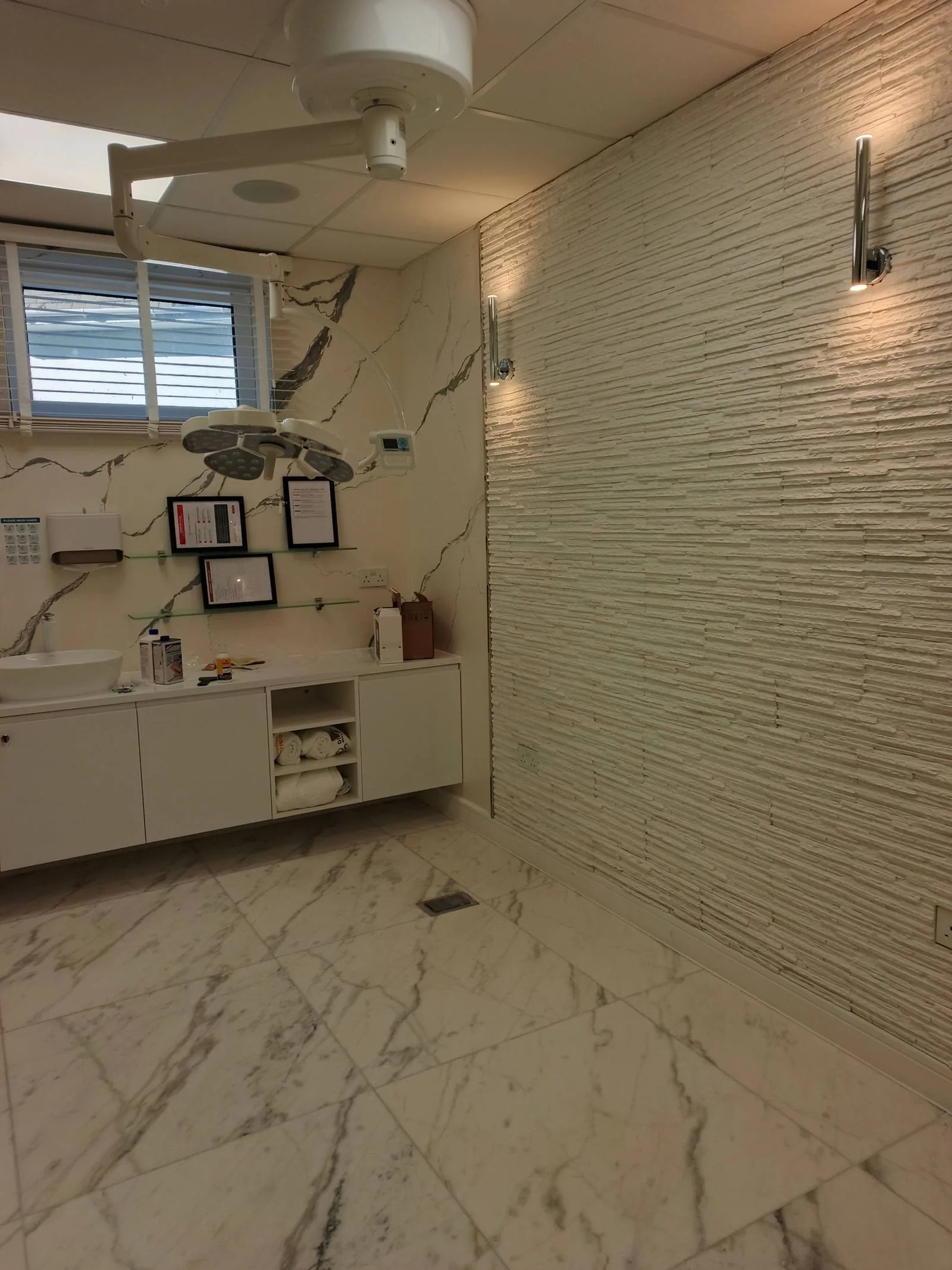 Treatment room with surgical light and wall lights in an aesthetic clinic, Poole BH14
