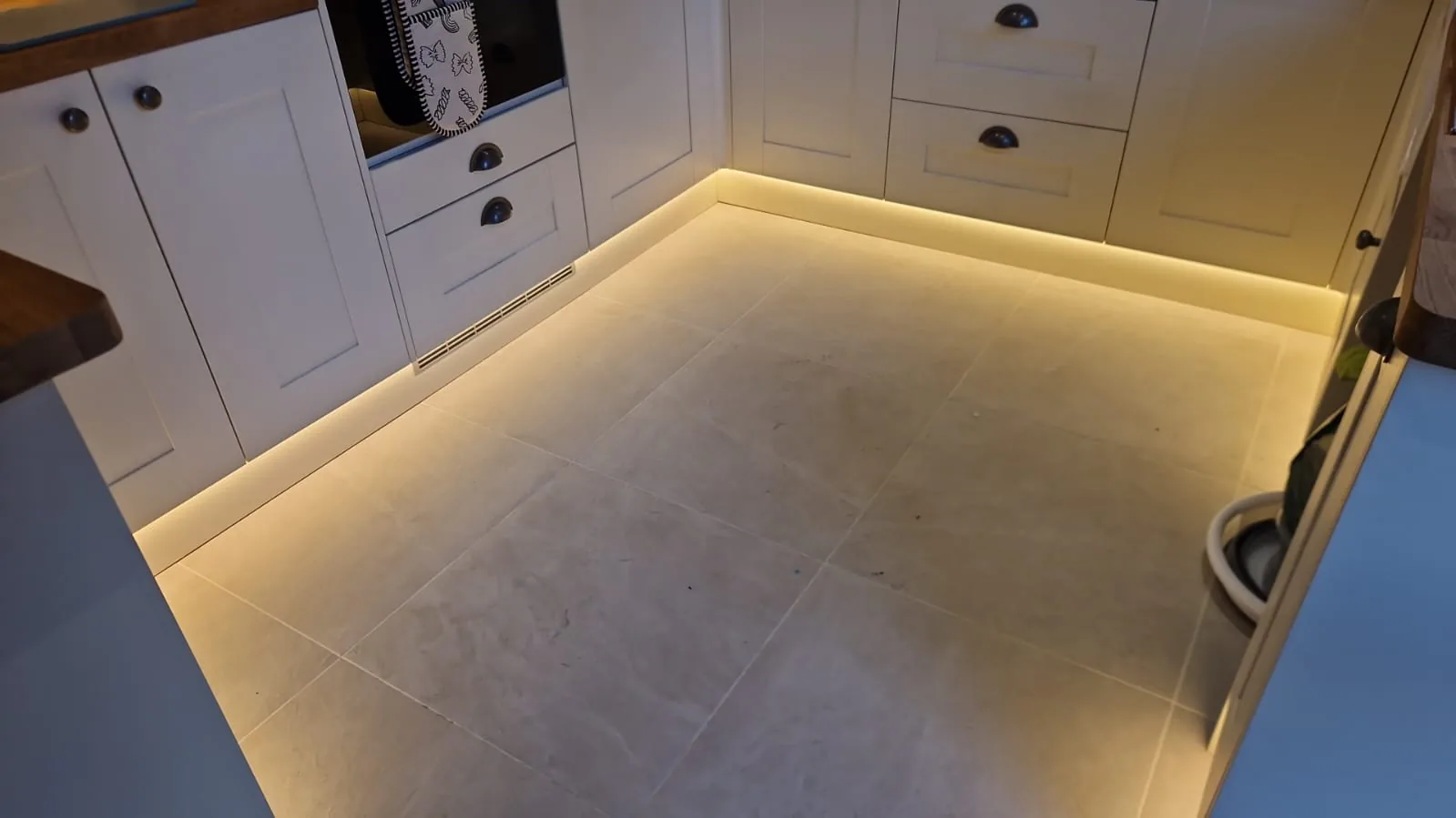 Warm LED plinth lighting fitted beneath kitchen base units in Bournemouth BH9