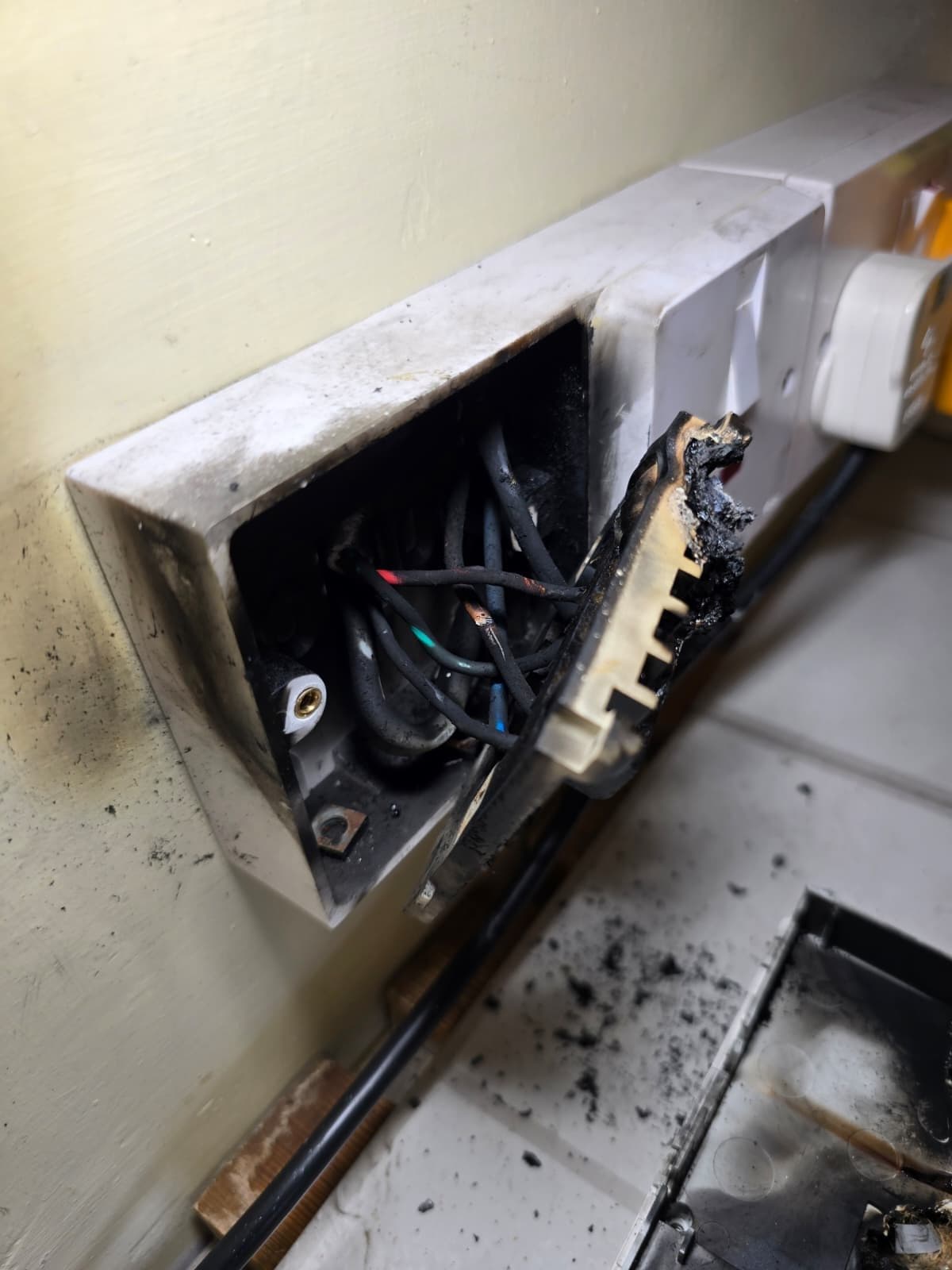 The plastic mounting box showing extreme thermal melting on the rear face.