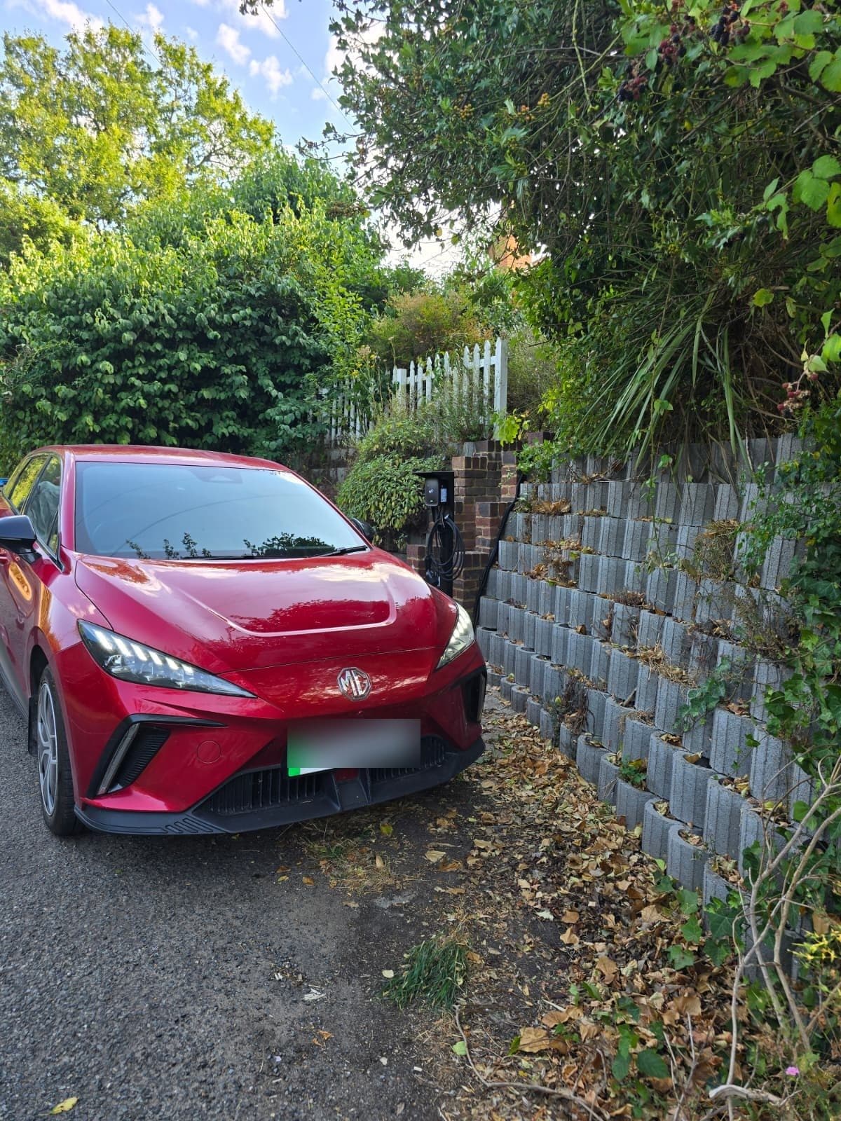 Completed charging station positioned cleanly at the head of the property driveway.