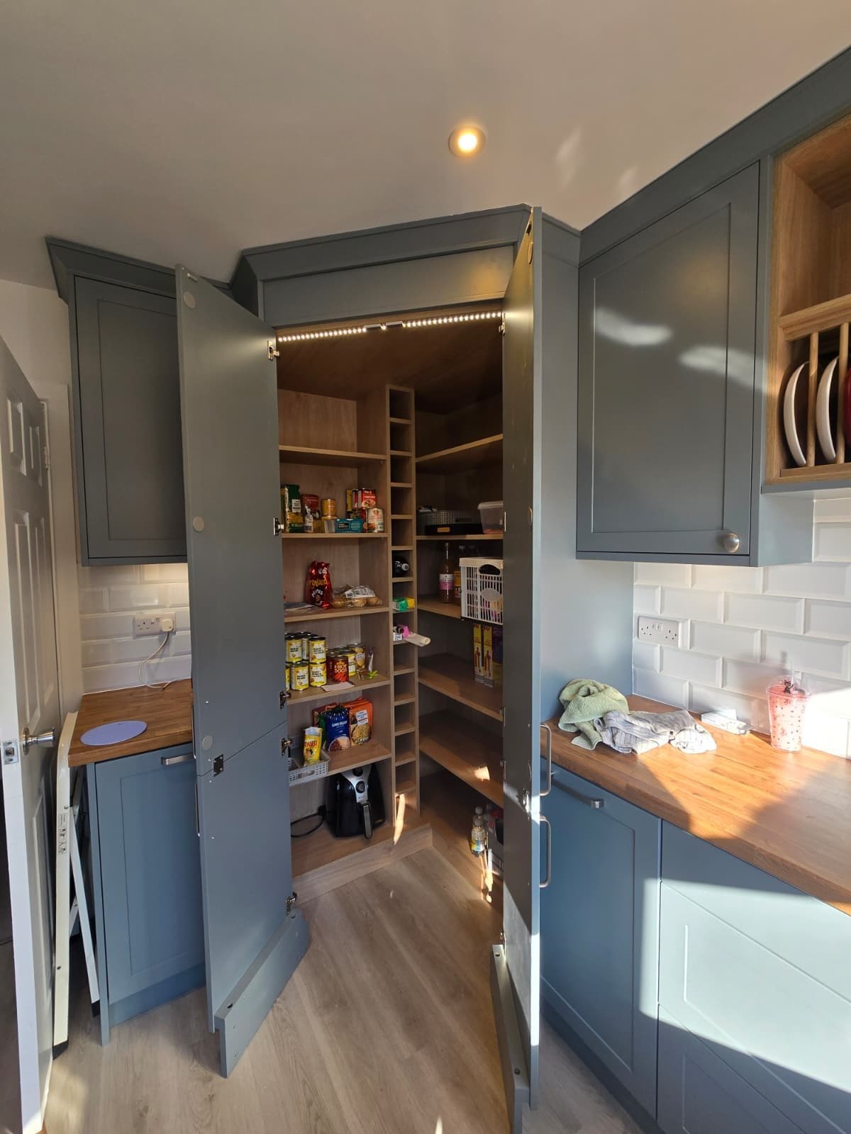 Dedicated switched fused connection unit installed inside a cupboard to power larder lighting.